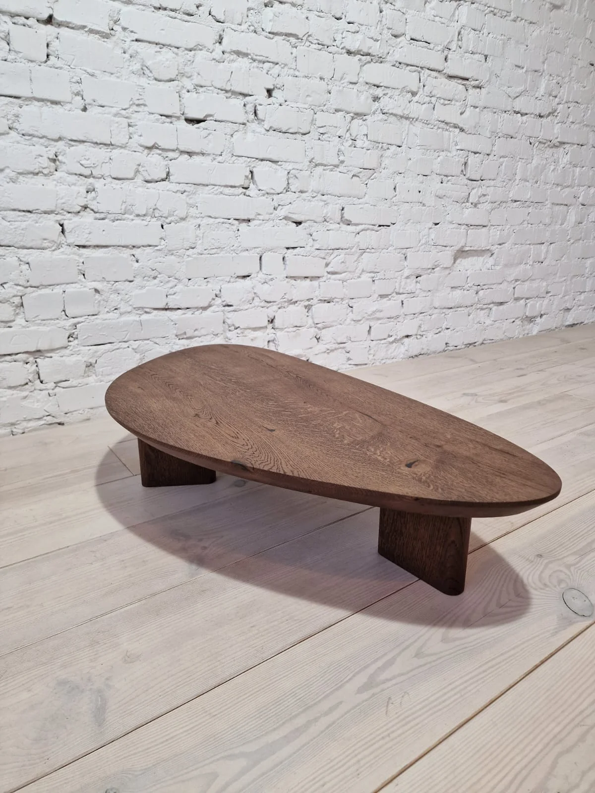 Oak Coffee Table - The Coffee Table showcases a beautifully organic shape crafted from solid oak - highlighting its naturally smooth surface and
