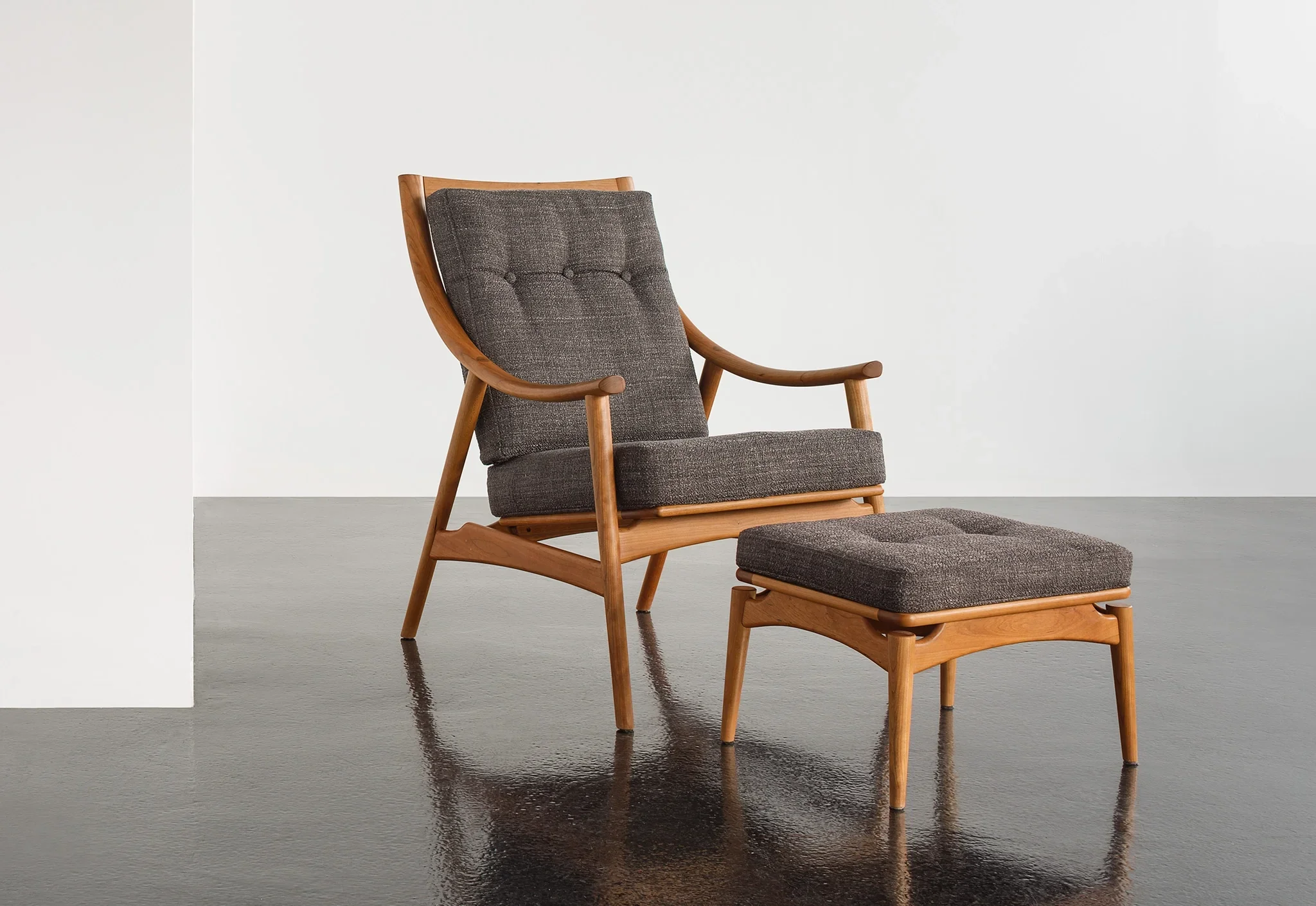 Lounge Chair - Designed with sweeping, curved arms, slender spindles along the back, and slender, gently raked legs