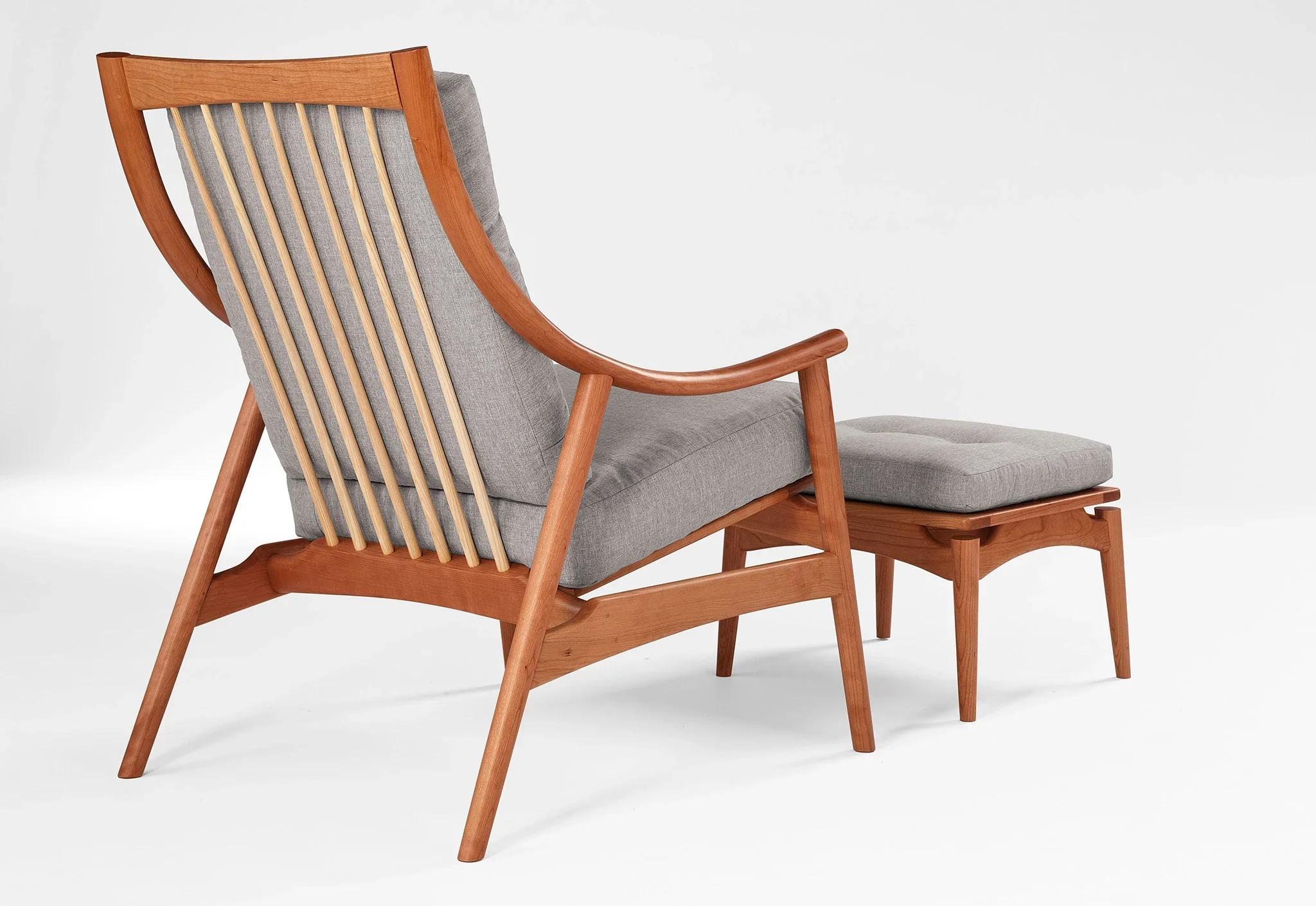 Lounge Chair - Designed with sweeping, curved arms, slender spindles along the back, and slender, gently raked legs